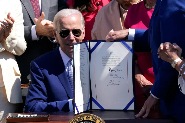 Government official signing legislation in the United States, highlighting the impact of semiconductor policies and opportunities for Mexico in OSAT assembly.