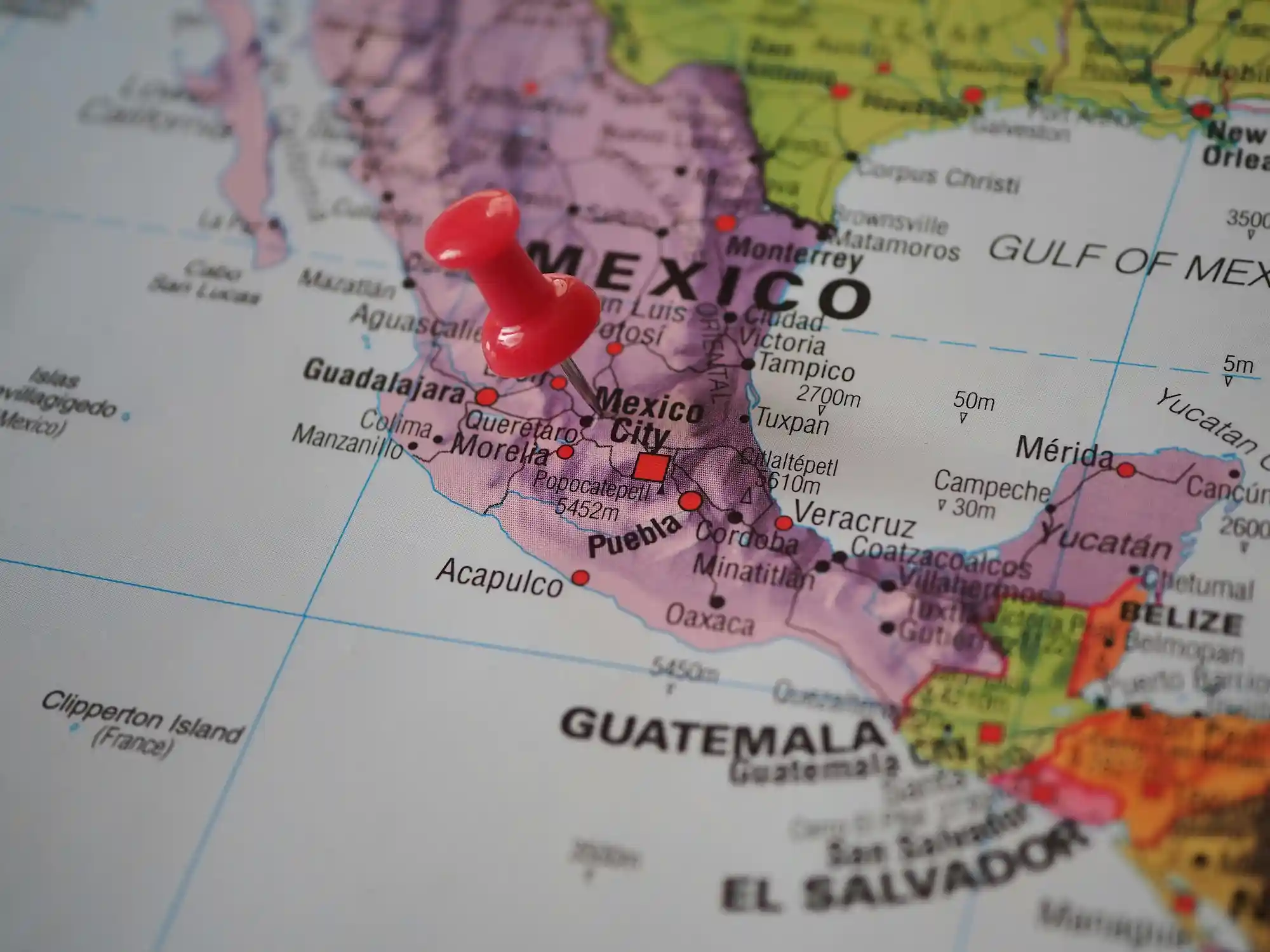 Close-up of a map of Mexico with a red pushpin marking Mexico City, symbolizing strategic business expansion opportunities.
