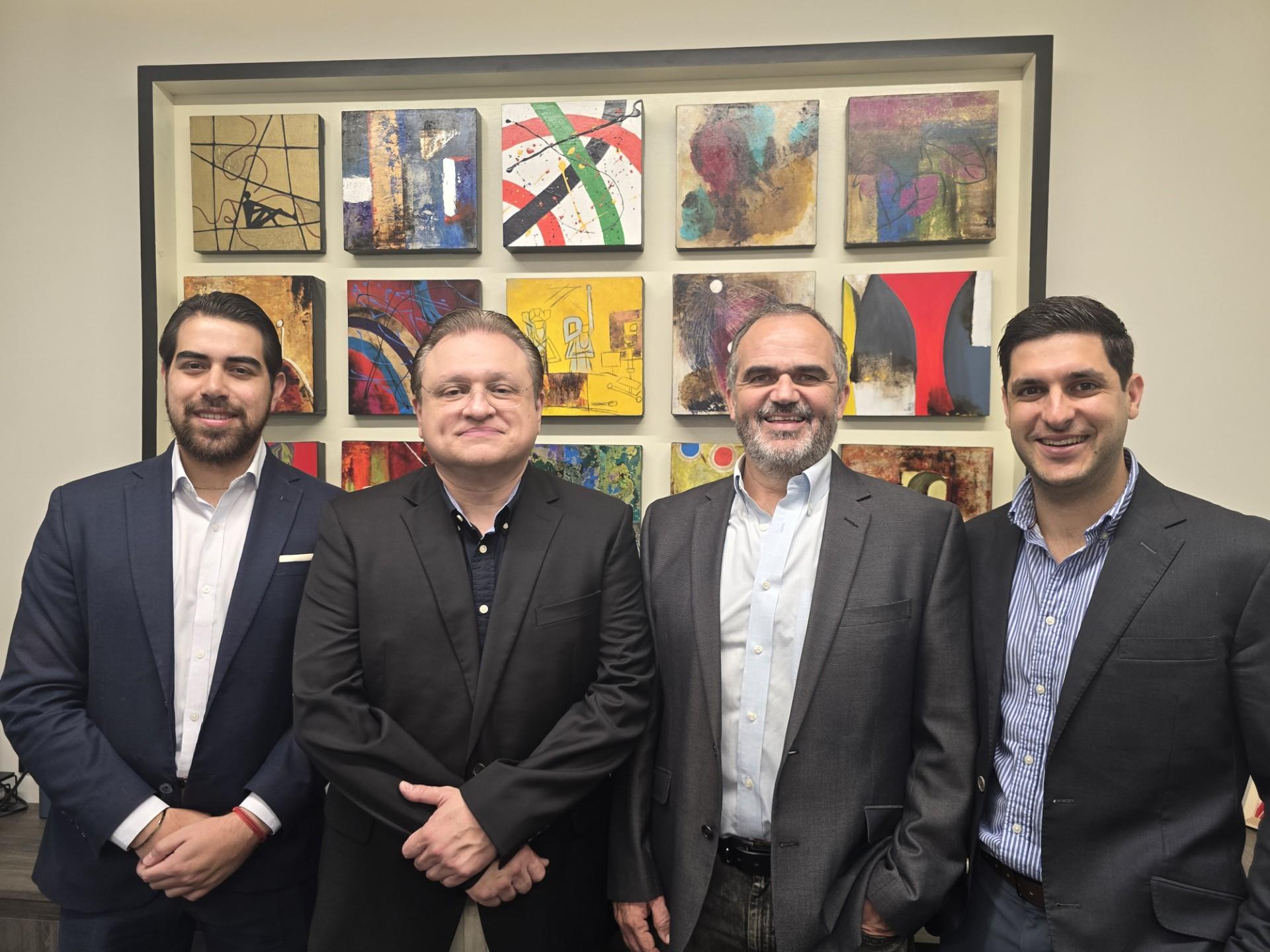 DIMSA executive team including the CEO, COO, Customer Success Director, and Business Development Director, standing together in the company office.