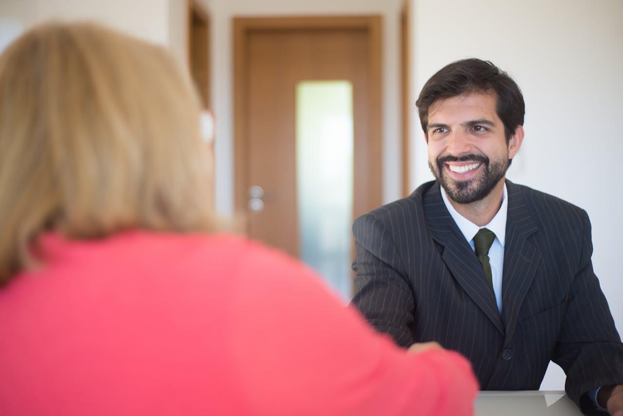 Recruiter interviewing candidate in a professional office setting, representing modern talent acquisition and hiring process