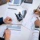 Foreign business team analyzing financial charts and operational data while planning company operations in Mexico