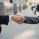 Business professionals shaking hands, representing strong banking relationship management for companies in Mexico