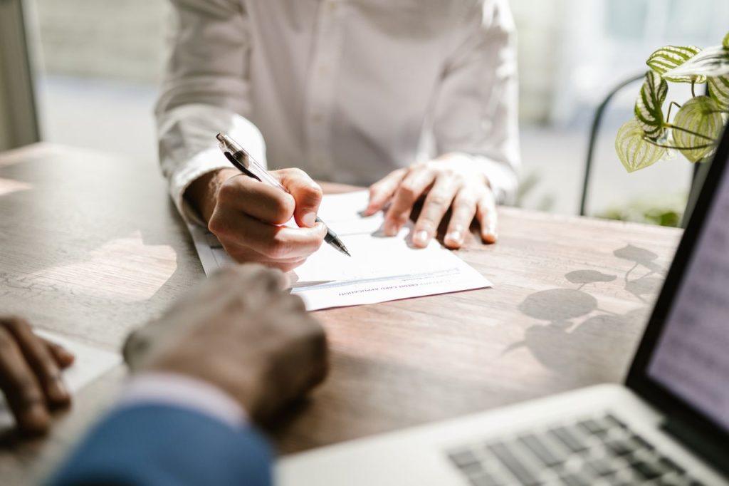 Business professional signing import documentation as part of Mexico's registration and compliance process