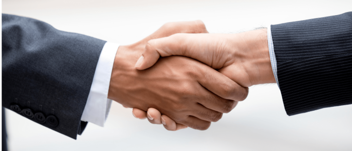 Strategic Business Agreement in Mexico Two professionals shaking hands, symbolizing a business partnership or successful establishment of operations in Mexico