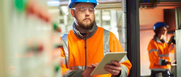 Workplace Safety & Operational Oversight Industrial worker with tablet inspecting facility, representing operational safety and compliance in Mexico